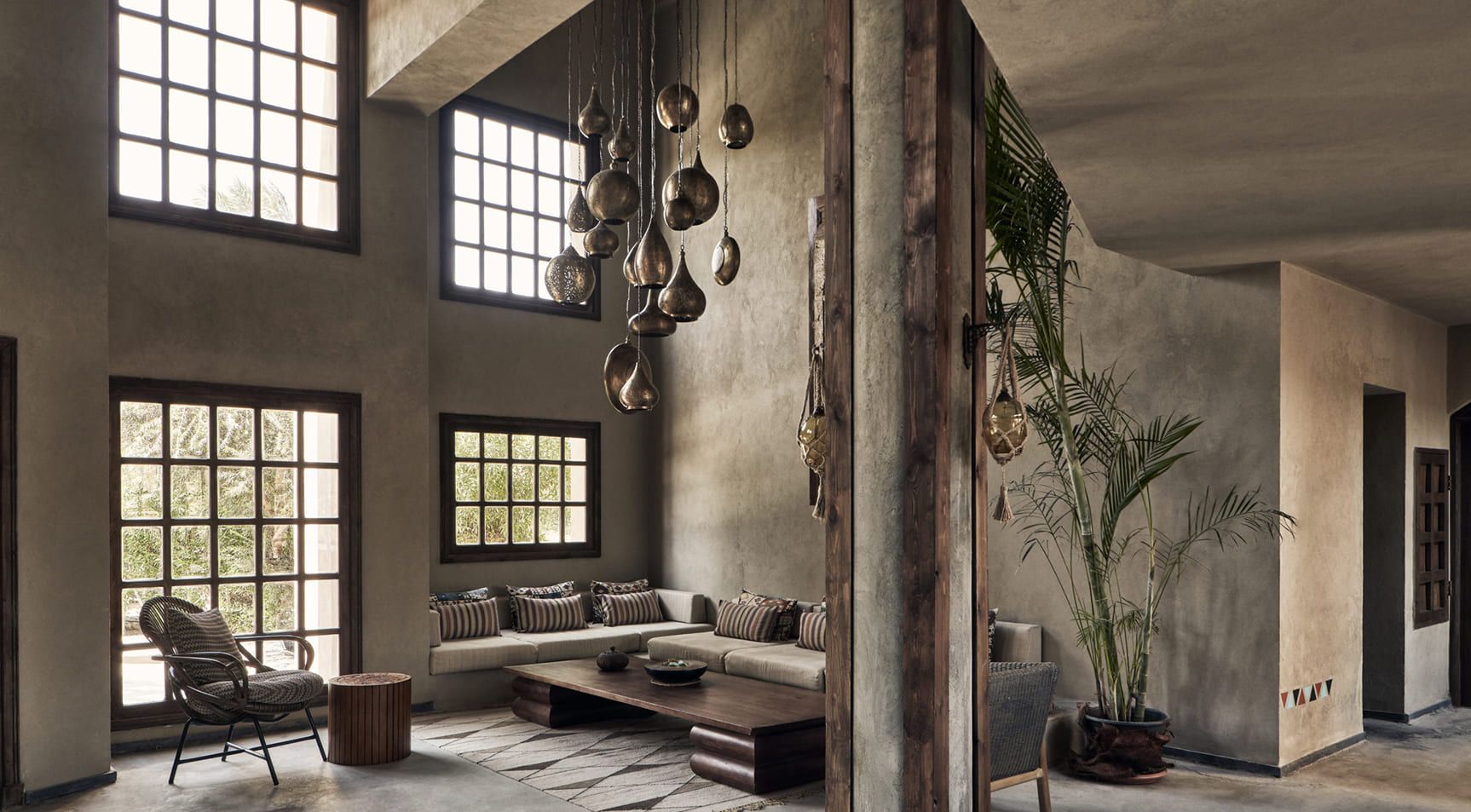 Cook’s Club Hotel lounge with tall windows and suspended pendant lights
